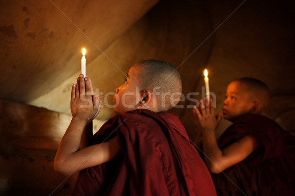 Buddhist novices praying Stock photo © szefei