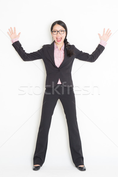 Shocked Asian businesswoman leaning wall Stock photo © szefei