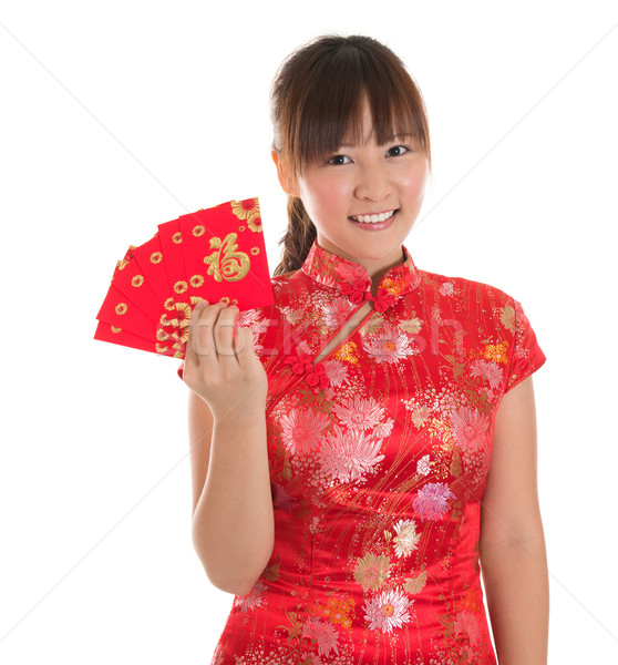 Chinese cheongsam girl showing red packets Stock photo © szefei
