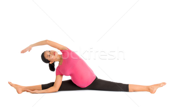 Pregnant yoga position seated side stretch. Stock photo © szefei
