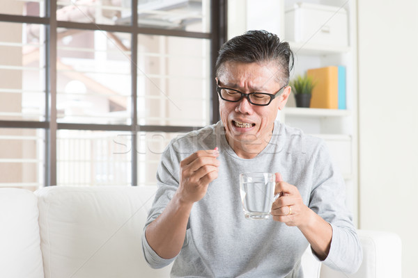 Maturo asian cinese uomo mangiare medicina Foto d'archivio © szefei