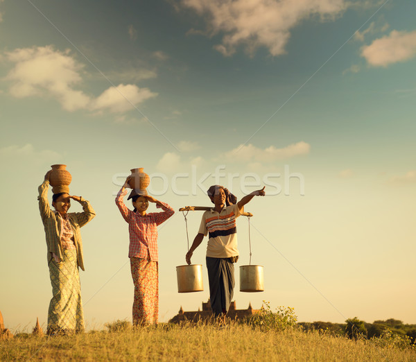 Group Asian Burmese traditional farmers in sunset Stock photo © szefei