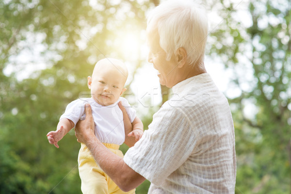 Grandparent and grandchild at outdoor park. Stock photo © szefei
