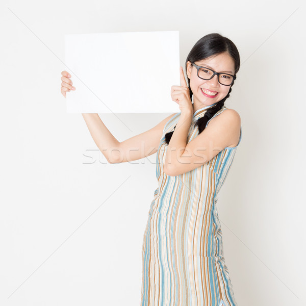 Asian girl holding white blank paper card Stock photo © szefei
