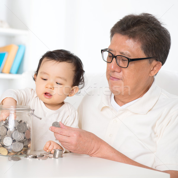 Asian family saving money Stock photo © szefei