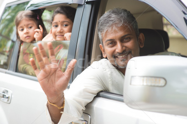 Indian family waving hands in car Stock photo © szefei