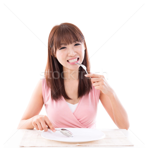 Stock photo: Dining concept, woman eating with empty plate