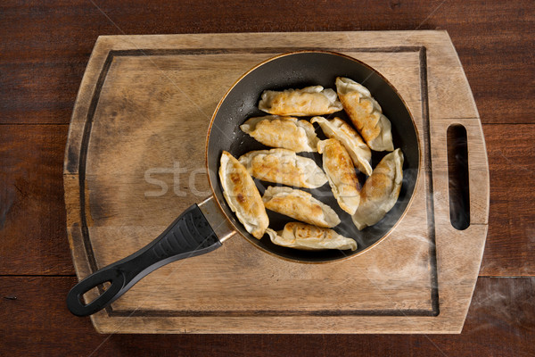 Asian meal fried dumpling in cooking pan Stock photo © szefei
