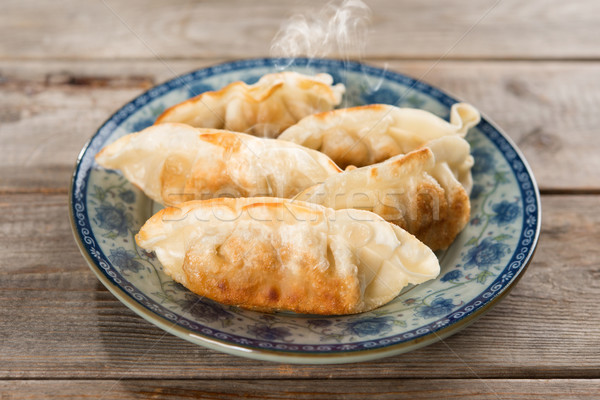 Asian food pan fried dumplings Stock photo © szefei