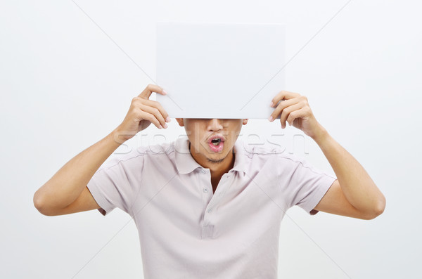 Asian man holding white card covering face Stock photo © szefei