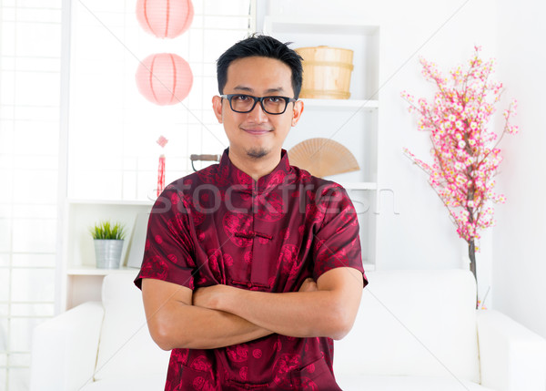 Chinese man standing indoors Stock photo © szefei
