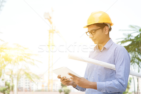Male contractor engineer reading on tablet pc Stock photo © szefei