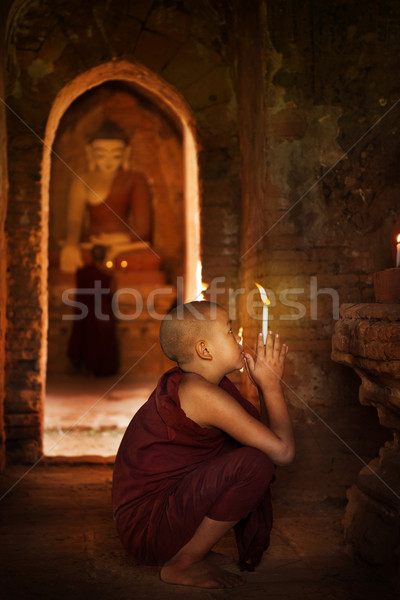 Buddhist novices praying in monastery  Stock photo © szefei