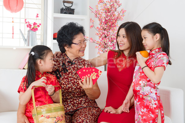 Asian family celebrate Chinese new year at home. Stock photo © szefei