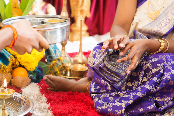 Indian woman received prayers from priest.  Stock photo © szefei