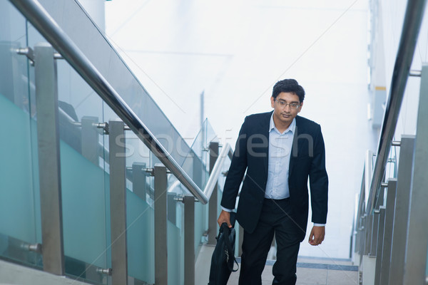 Asian Indian businessman ascending steps Stock photo © szefei