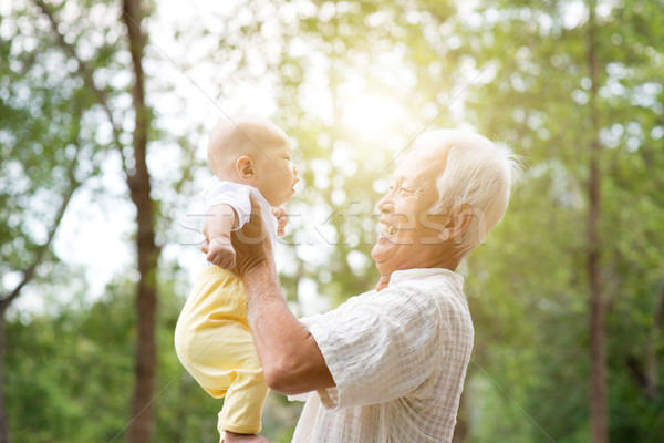 Grandparent playing with grandchild. Stock photo © szefei