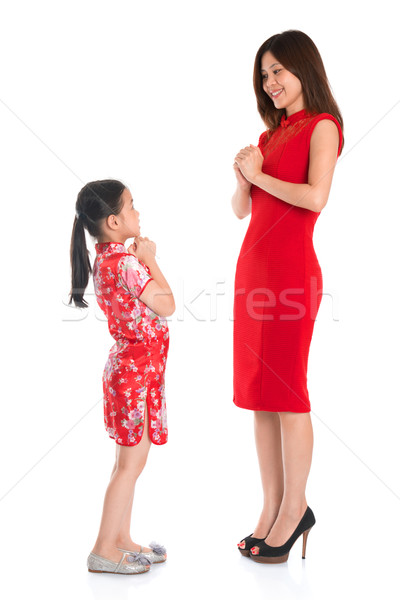 Full length Chinese parent and child greeting to each other Stock photo © szefei