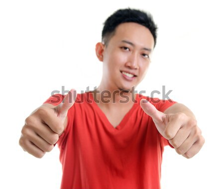 Thumb up cool young Southeast Asian man Stock photo © szefei
