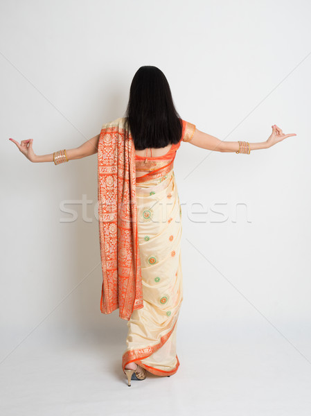 Rear view female in Indian sari dress dancing Stock photo © szefei