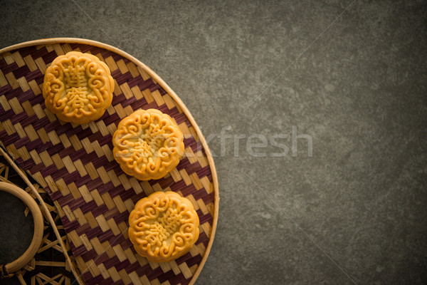 Moon cakes on bamboo background low light with copyspace  Stock photo © szefei