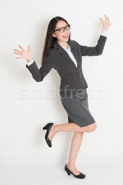 Full body cheering Asian business woman  Stock photo © szefei