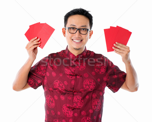 Asian Chinese man holding red packet  Stock photo © szefei