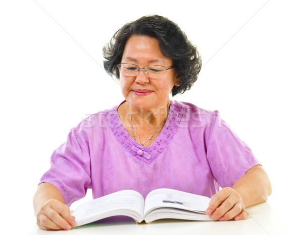 Asian senior woman serious reading Stock photo © szefei