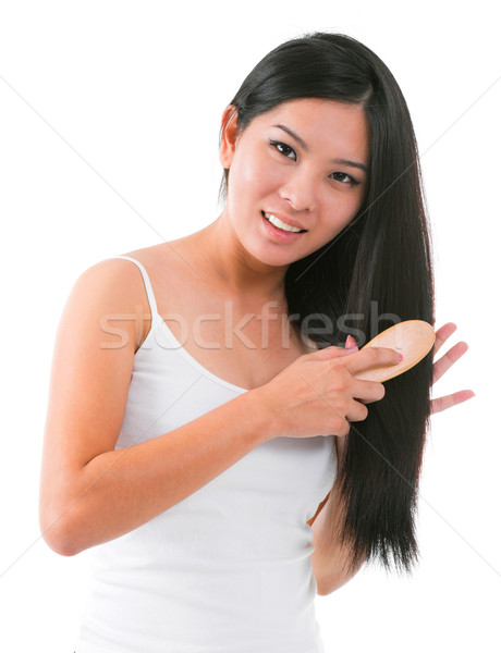 Asian girl combing hair Stock photo © szefei