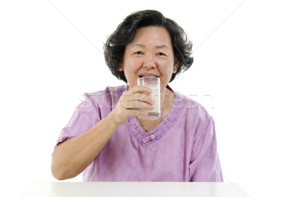 Senior adult woman drinking soy milk Stock photo © szefei