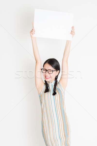 Chinese girl holding white blank paper card Stock photo © szefei