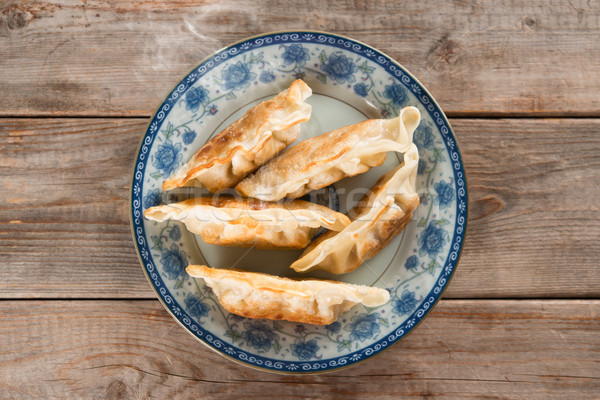 Asian gourmet pan fried dumplings Stock photo © szefei