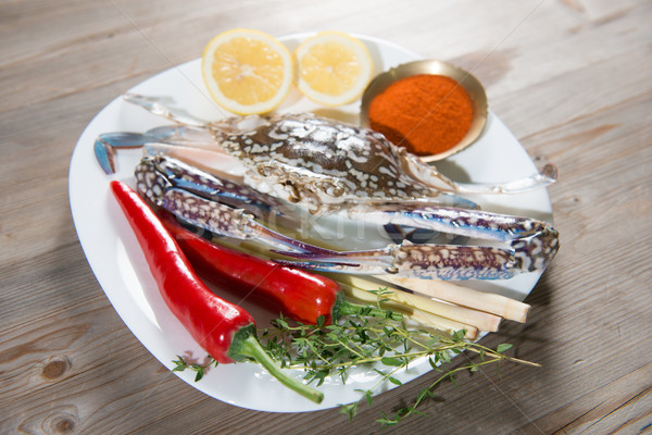 Raw blue crab and ingredients on white plate Stock photo © szefei