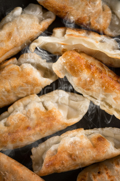 Close up fried dumpling in cooking pan Stock photo © szefei