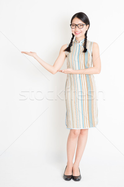Asian girl showing something Stock photo © szefei