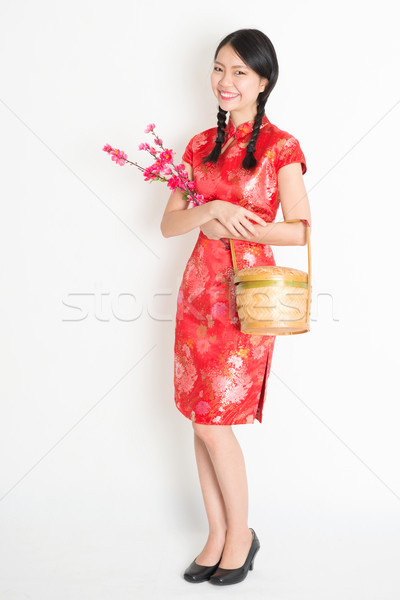 Chinese girl holding gift basket and plum blossom Stock photo © szefei