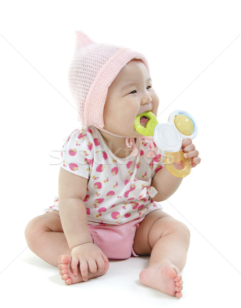 Asian baby girl teething Stock photo © szefei