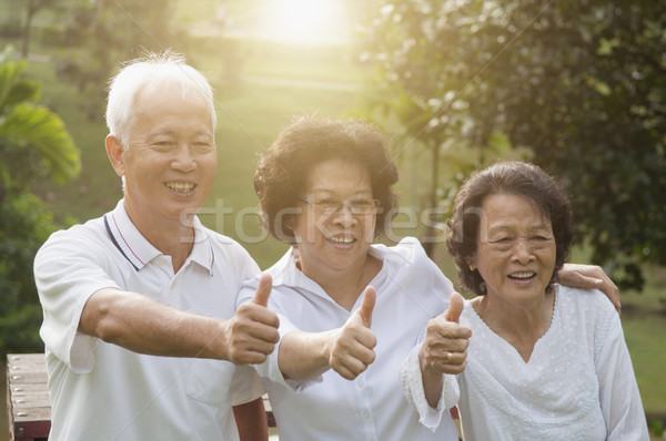 Group of Asian seniors showing thumbs up Stock photo © szefei