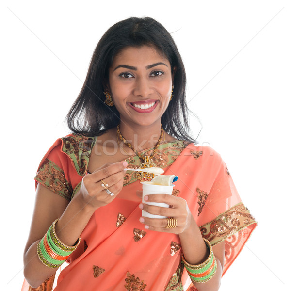 Stock photo: Traditional Indian woman eating yogurt