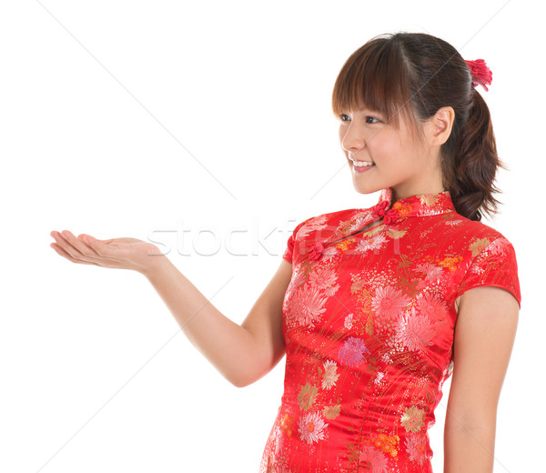 Chinese cheongsam girl showing empty palm Stock photo © szefei