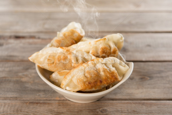 Famous Asian appetizer pan fried dumplings Stock photo © szefei