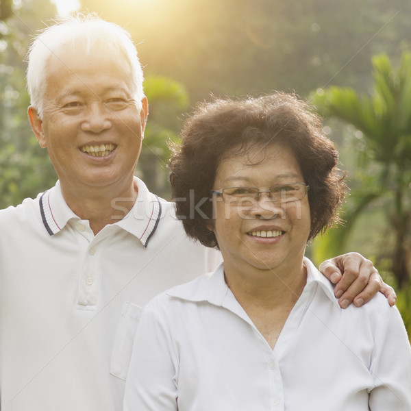 Loving Asian seniors couple outdoors Stock photo © szefei