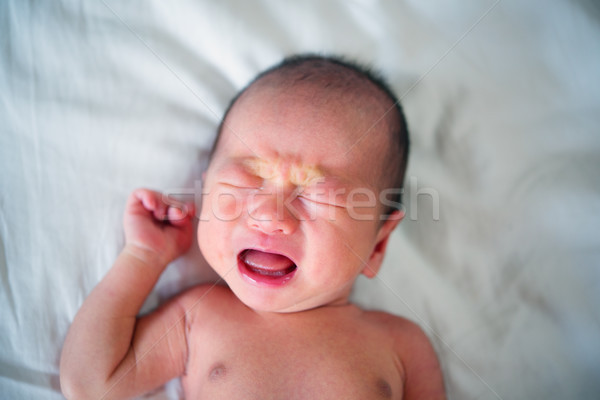 New born baby boy crying Stock photo © szefei