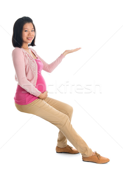 Pregnant Asian woman hand showing empty space Stock photo © szefei