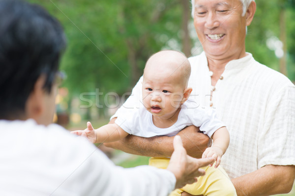 Asian grandparents playing with grandchild Stock photo © szefei