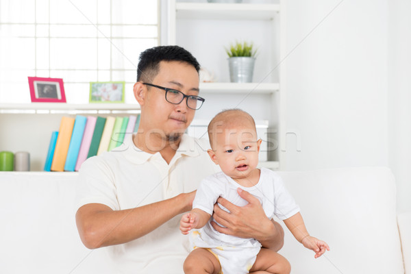 Father burping baby after meal Stock photo © szefei