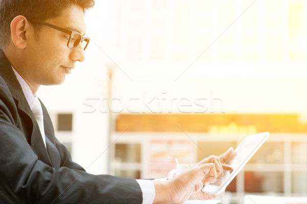 Indian business people using tablet pc at cafe Stock photo © szefei
