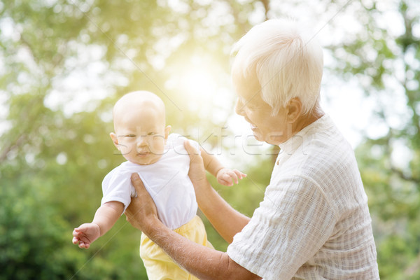 Grandparent taking care grandchild. Stock photo © szefei