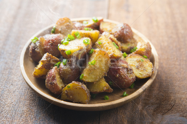 Oven roasted potatoes on plate ready to serve Stock photo © szefei