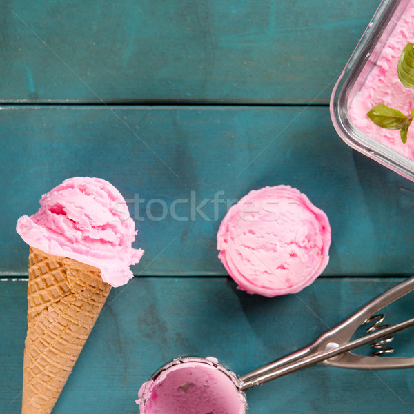 Pink ice cream in blue background Stock photo © szefei
